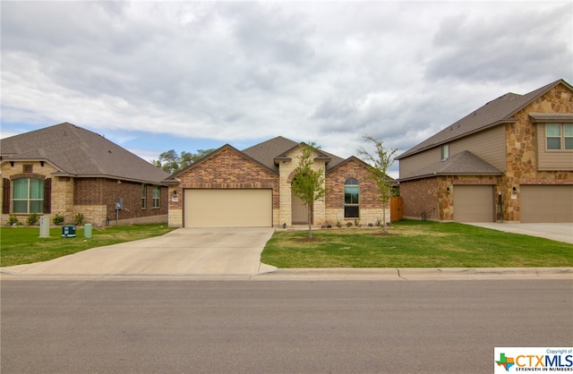 view of front of property featuring a garage and a front yard