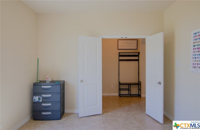 unfurnished bedroom with light tile patterned floors