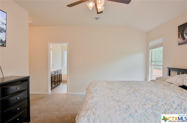 carpeted bedroom featuring connected bathroom, vaulted ceiling, and ceiling fan