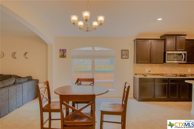 dining area featuring a chandelier and light tile patterned floors