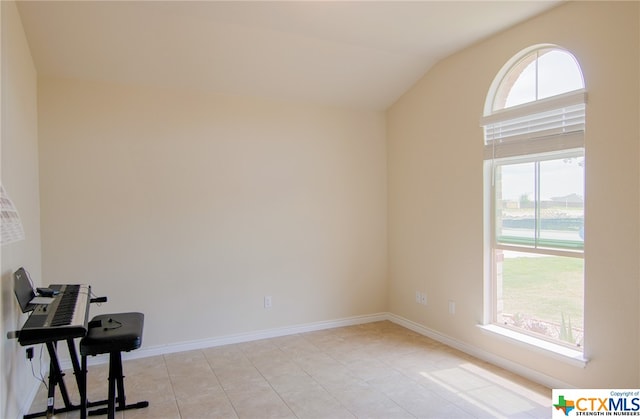 interior space featuring lofted ceiling, light tile patterned floors, and plenty of natural light