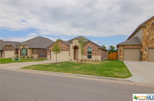 view of front of property with a front lawn and a garage