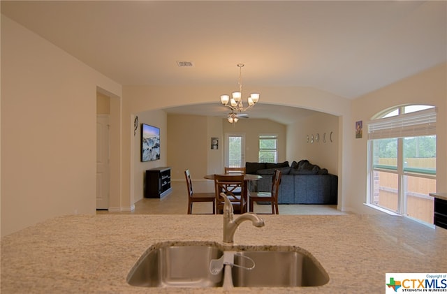 kitchen with pendant lighting, a wealth of natural light, sink, and lofted ceiling