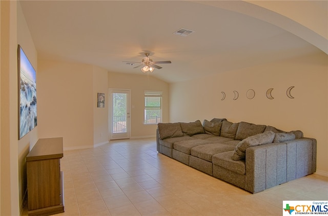 tiled living room featuring ceiling fan and vaulted ceiling