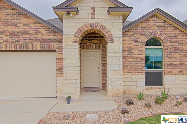 doorway to property with a garage