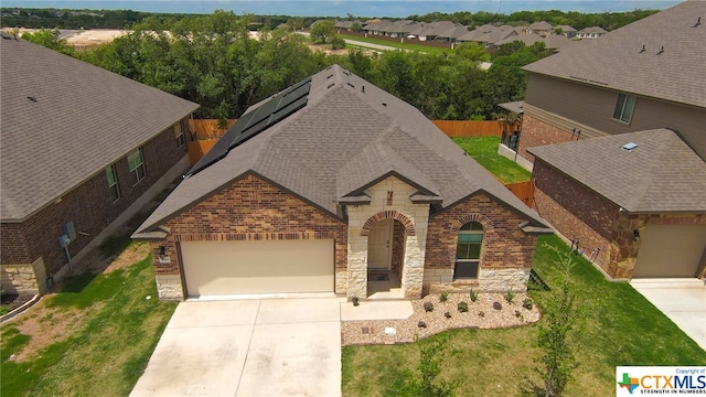 view of front facade featuring a garage and a front lawn