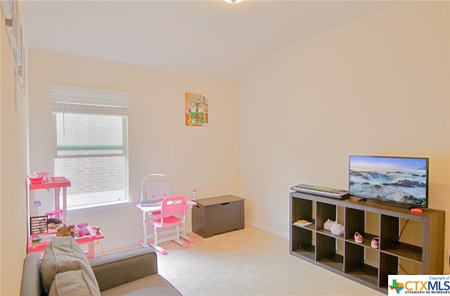 game room with light tile patterned floors and vaulted ceiling