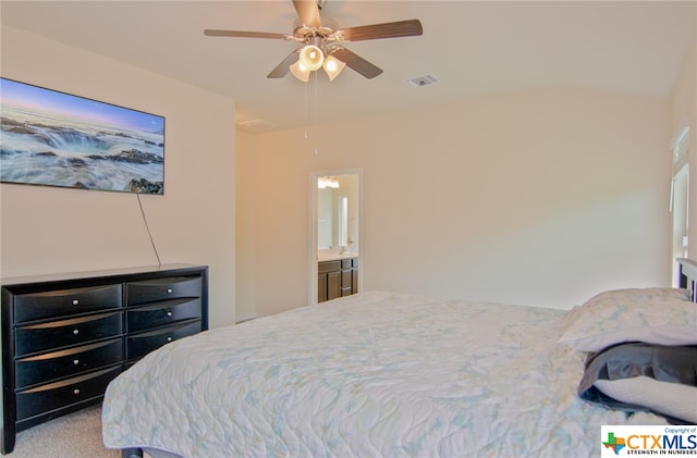 carpeted bedroom with ensuite bathroom and ceiling fan