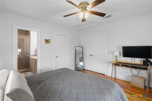 104 E Stayton Ave, Victoria, TX 77901 - bedroom with visible vents, ensuite bathroom, wood finished floors, attic access, and ceiling fan