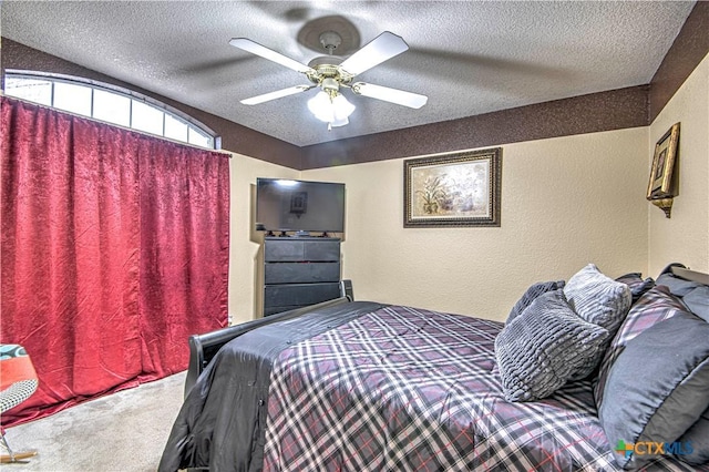 carpeted bedroom featuring a textured ceiling and ceiling fan