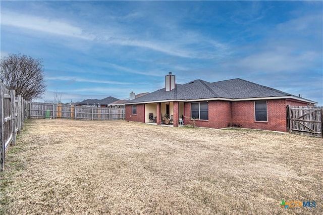 rear view of house with a lawn