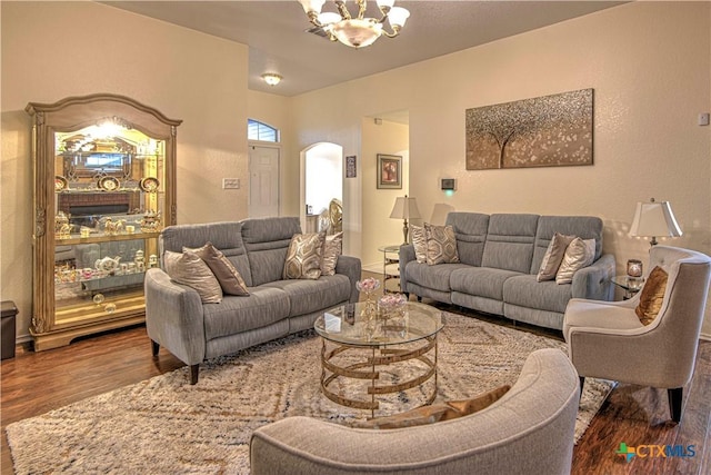 living room with an inviting chandelier and dark hardwood / wood-style flooring