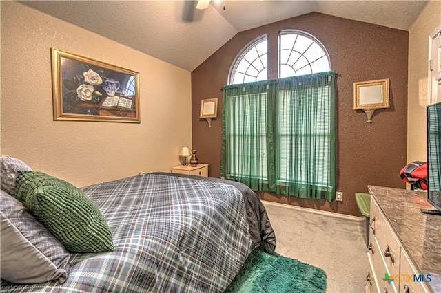 bedroom featuring ceiling fan, vaulted ceiling, and carpet