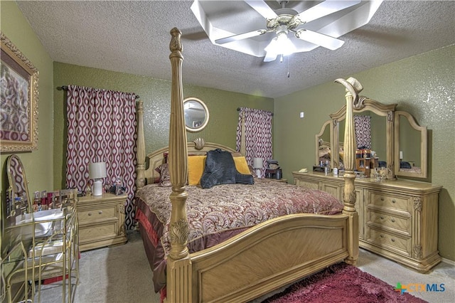 carpeted bedroom with a textured ceiling and ceiling fan