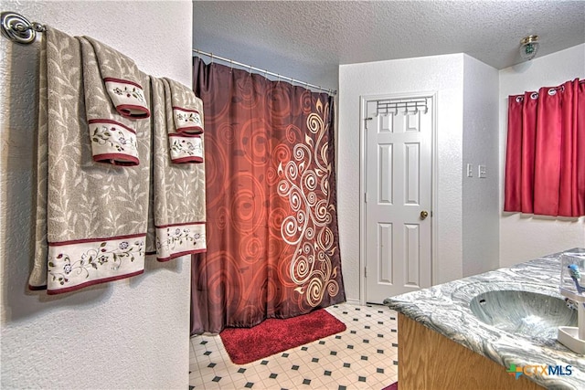 bathroom featuring vanity and a textured ceiling