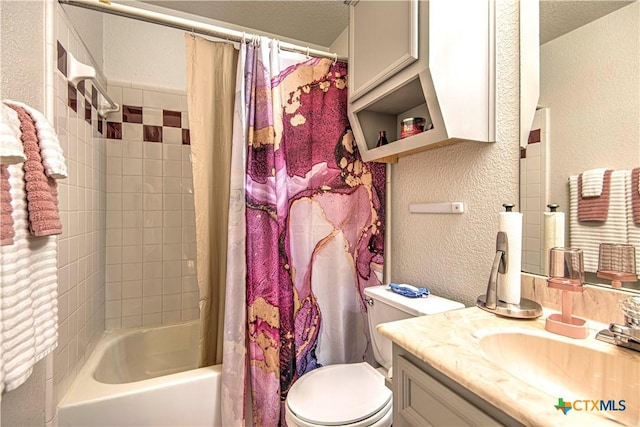 full bathroom featuring vanity, shower / bath combo, a textured ceiling, and toilet