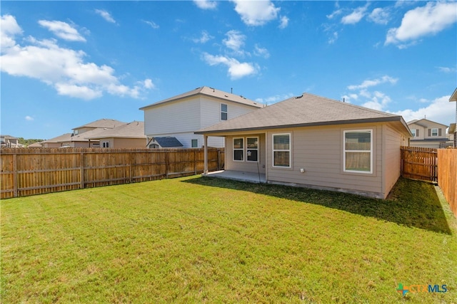 back of property featuring a patio and a yard