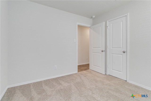 unfurnished bedroom with light carpet