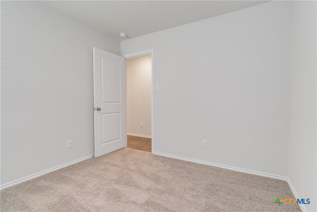 2969 Wolfcreek, New Braunfels, TX 78130 - unfurnished room featuring carpet floors, baseboards, and a smoke detector
