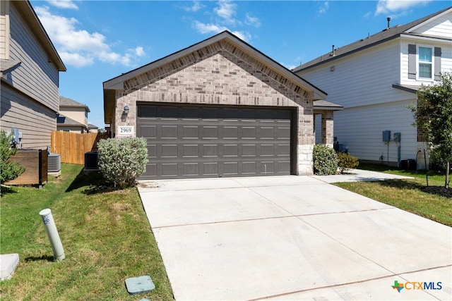 view of front of house featuring central AC unit, a garage, and a front yard