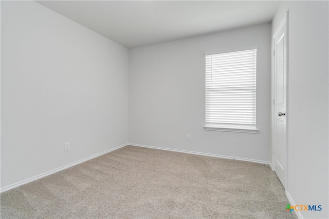 empty room featuring light colored carpet