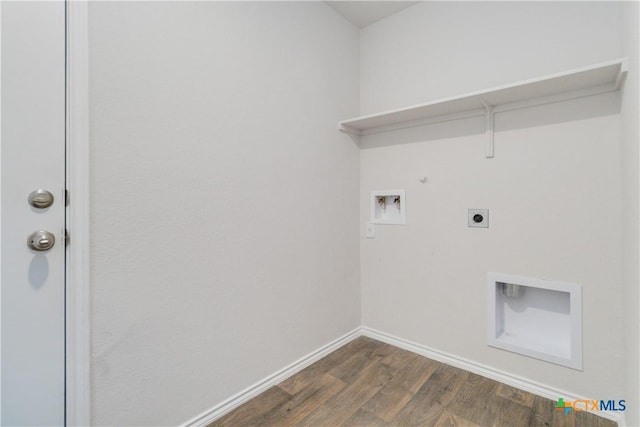 2969 Wolfcreek, New Braunfels, TX 78130 - washroom featuring electric dryer hookup, dark wood-style flooring, washer hookup, baseboards, and gas dryer hookup