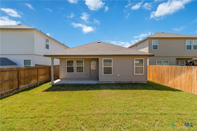 back of property with a lawn and a patio area