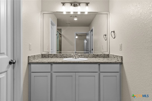 bathroom with ceiling fan and vanity