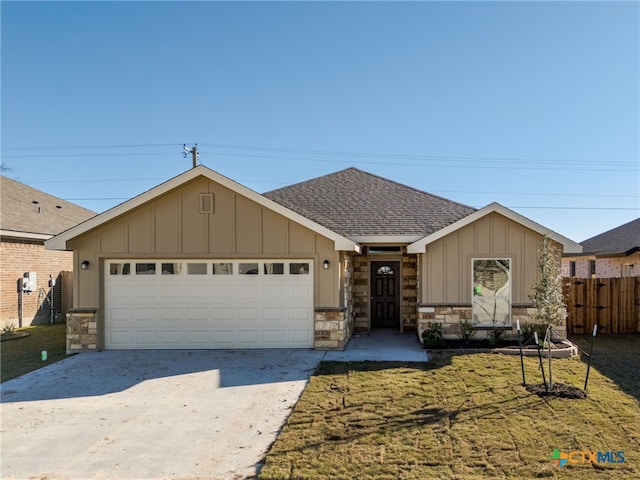 view of front of property with a garage and a front lawn