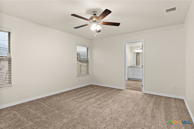 unfurnished room featuring light carpet