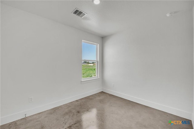 unfurnished room with concrete floors