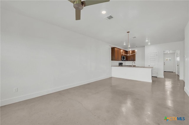 unfurnished living room with sink and ceiling fan