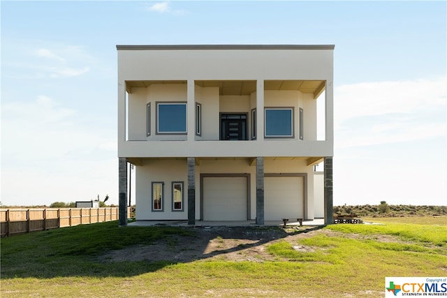 view of front of property with a front lawn and a garage