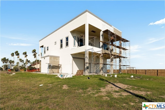 rear view of property with a lawn