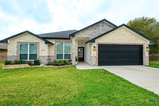 view of front of property featuring a garage and a front lawn