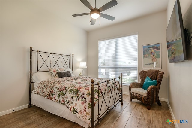 bedroom featuring hardwood / wood-style flooring and ceiling fan