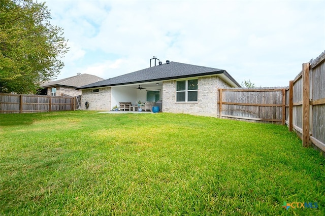 rear view of house with a lawn, a patio, and ceiling fan