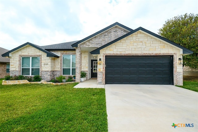 view of front of property featuring a garage, a shingled roof, brick siding, concrete driveway, and a front yard