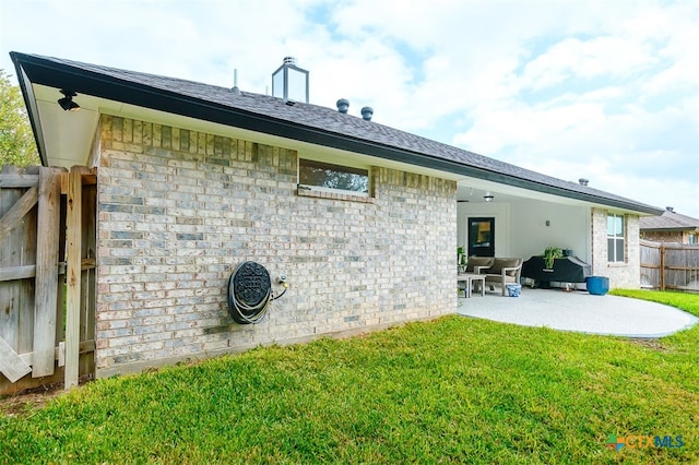 rear view of property with a patio and a yard