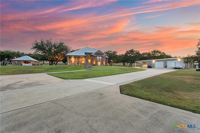 view of front of home with a lawn and a garage