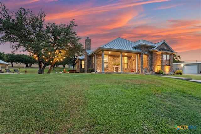 view of front of property featuring a garage and a yard