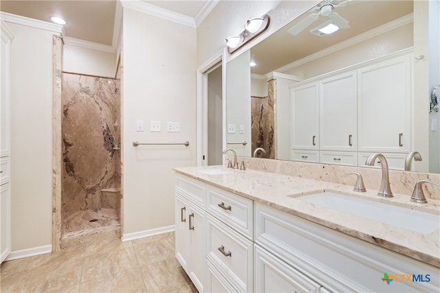 bathroom featuring vanity, a tile shower, and ornamental molding