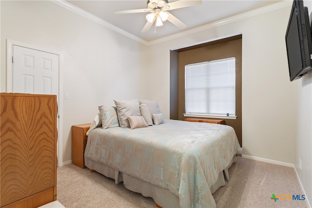 carpeted bedroom featuring ceiling fan and crown molding