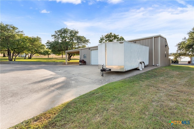 view of outbuilding featuring a garage and a yard