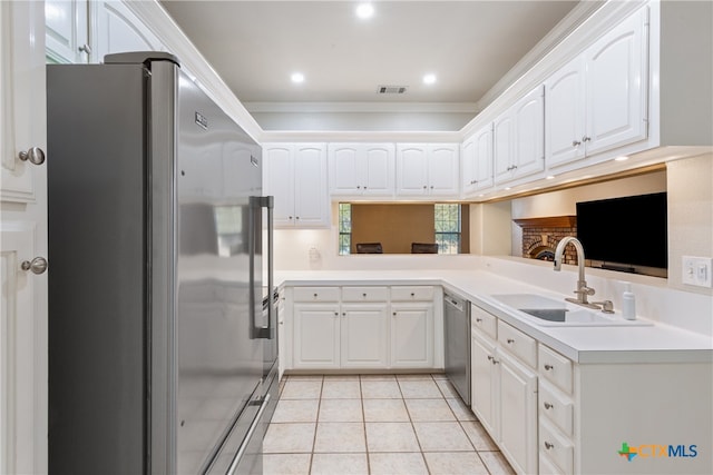 kitchen with stainless steel appliances, white cabinetry, sink, and crown molding