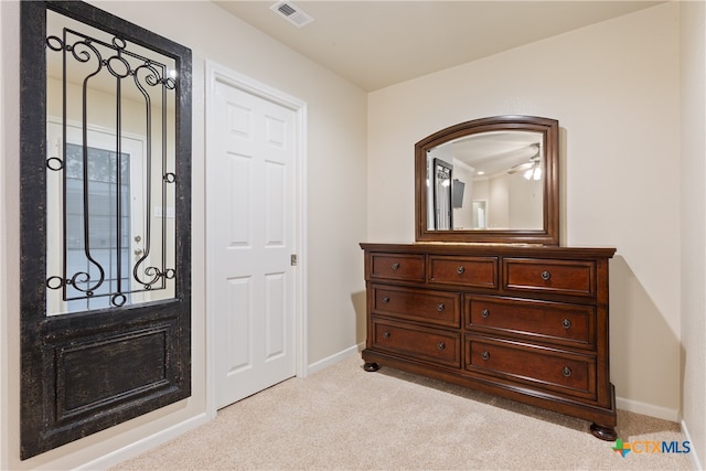 foyer entrance featuring light colored carpet