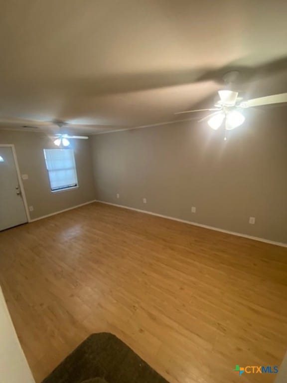 720 S Laurel Ave, Luling, TX 78648 - spare room featuring light wood-style flooring and ceiling fan