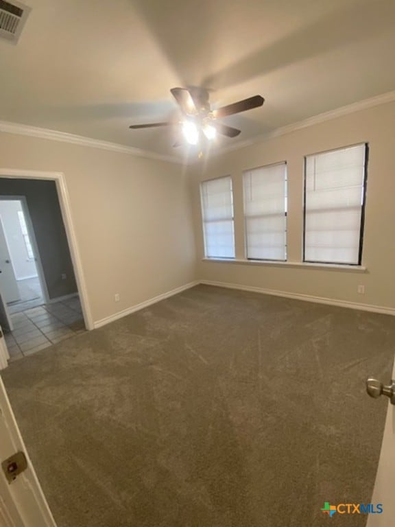 720 S Laurel Ave, Luling, TX 78648 - unfurnished room featuring ceiling fan, dark colored carpet, and crown molding
