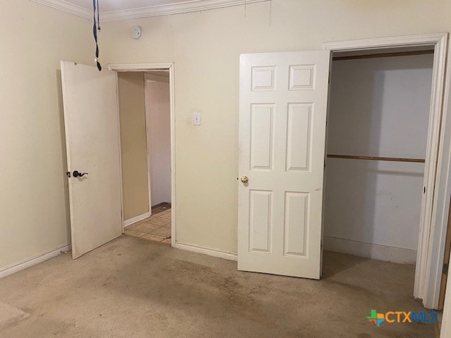 unfurnished bedroom featuring light carpet and ornamental molding