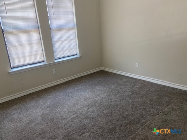 720 S Laurel Ave, Luling, TX 78648 - empty room with dark carpet and baseboards